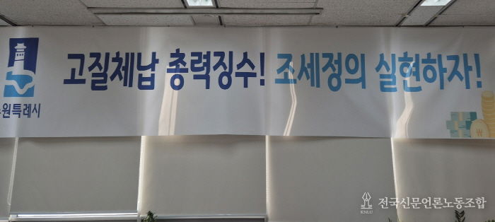 ‘고질체납 총력 징수! 조세정의 실현하자!’ 수원시 징수과 사무실에 걸려 있는 현수막.